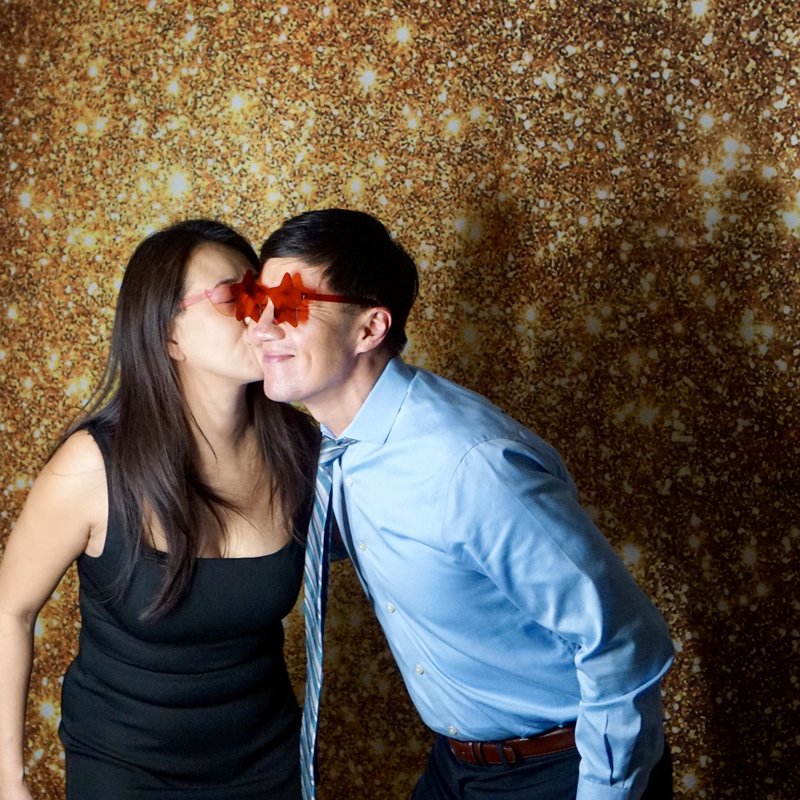 Couple with fun star glasses at photo booth