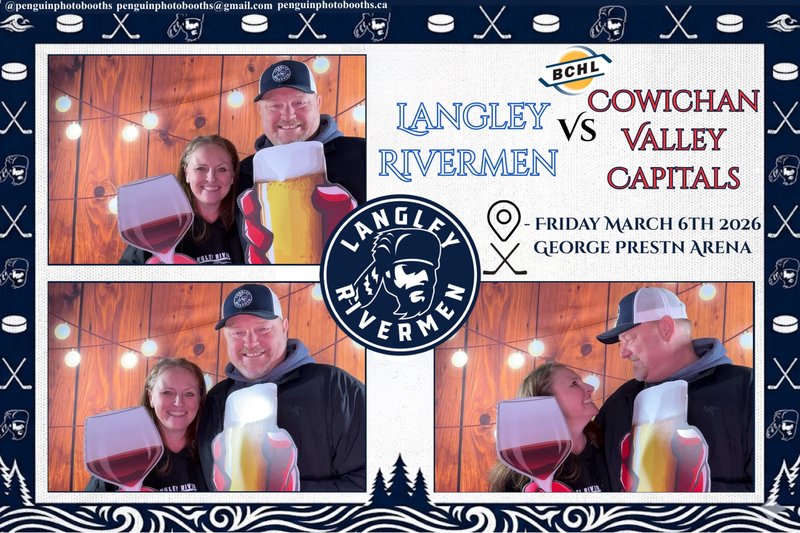 Couple posing with props at hockey game photo booth